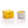 Candela da massaggio al miele Vivalu in contenitore bianco con scatola gialla accanto.