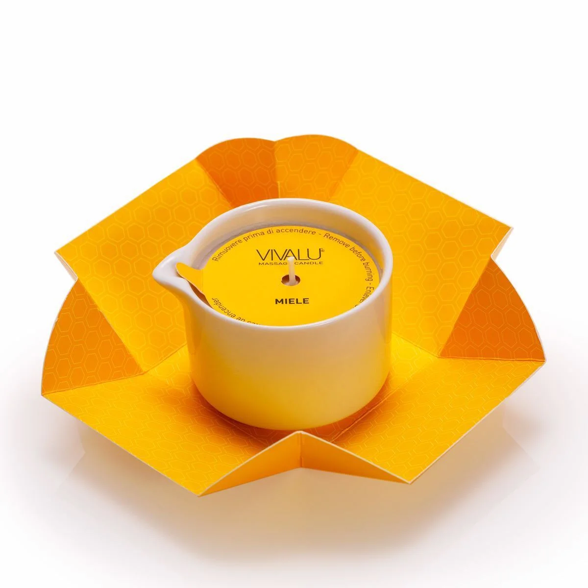 Candela da massaggio Vivalu al miele in confezione aperta con protezione in cartone giallo.
