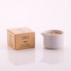 Candela da massaggio all'argan Vivalu in contenitore bianco con scatola color oro accanto.