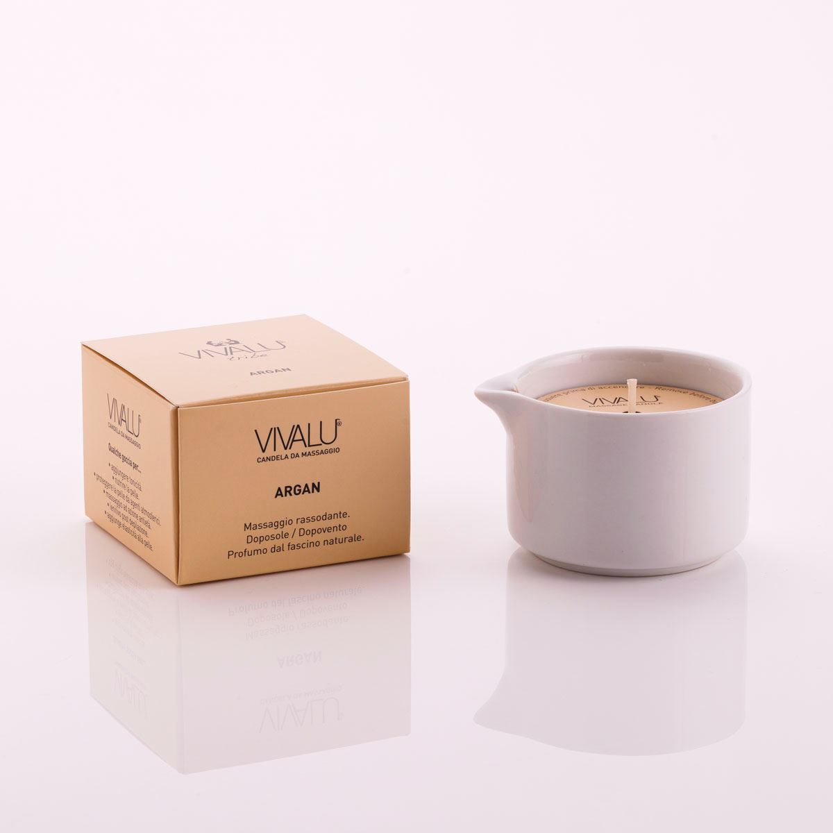 Candela da massaggio all'argan Vivalu in contenitore bianco con scatola color oro accanto.