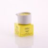 Candela da massaggio ai vinaccioli d'uva Vivalu posizionata sulla scatola color giallo, con proprietà anti-age e profumo fruttato.